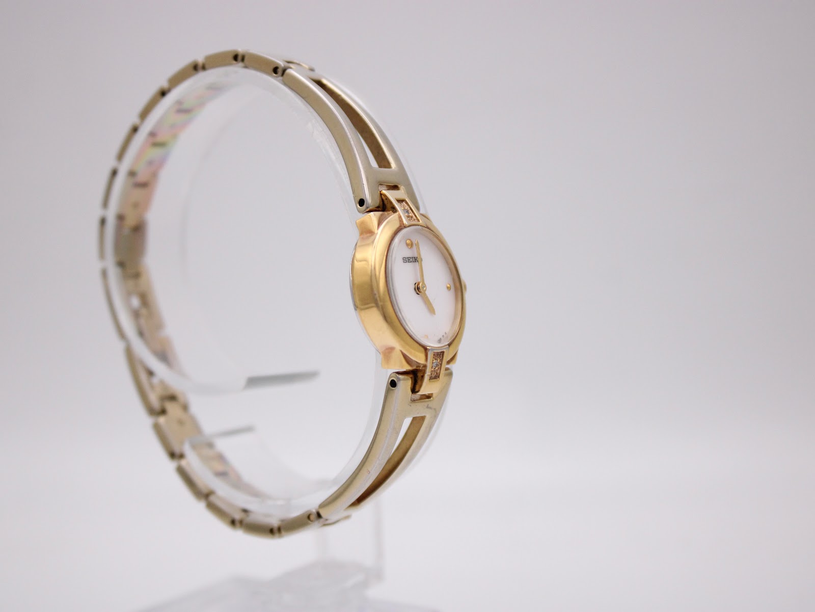 Another angled side view of the Seiko watch, showing the full circular shape of the bangle bracelet.
