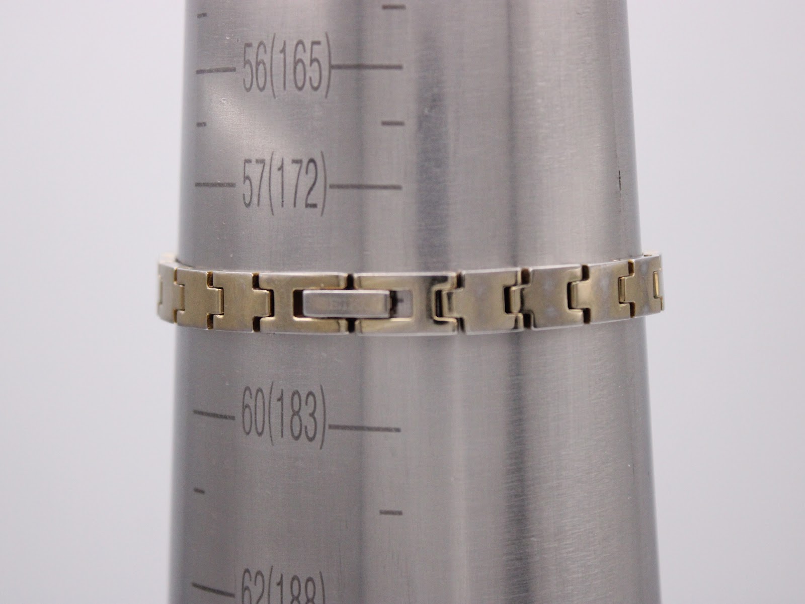 The watch bracelet clasped around a wrist sizing cone, indicating a wrist circumference of 165mm or 16.5cm.