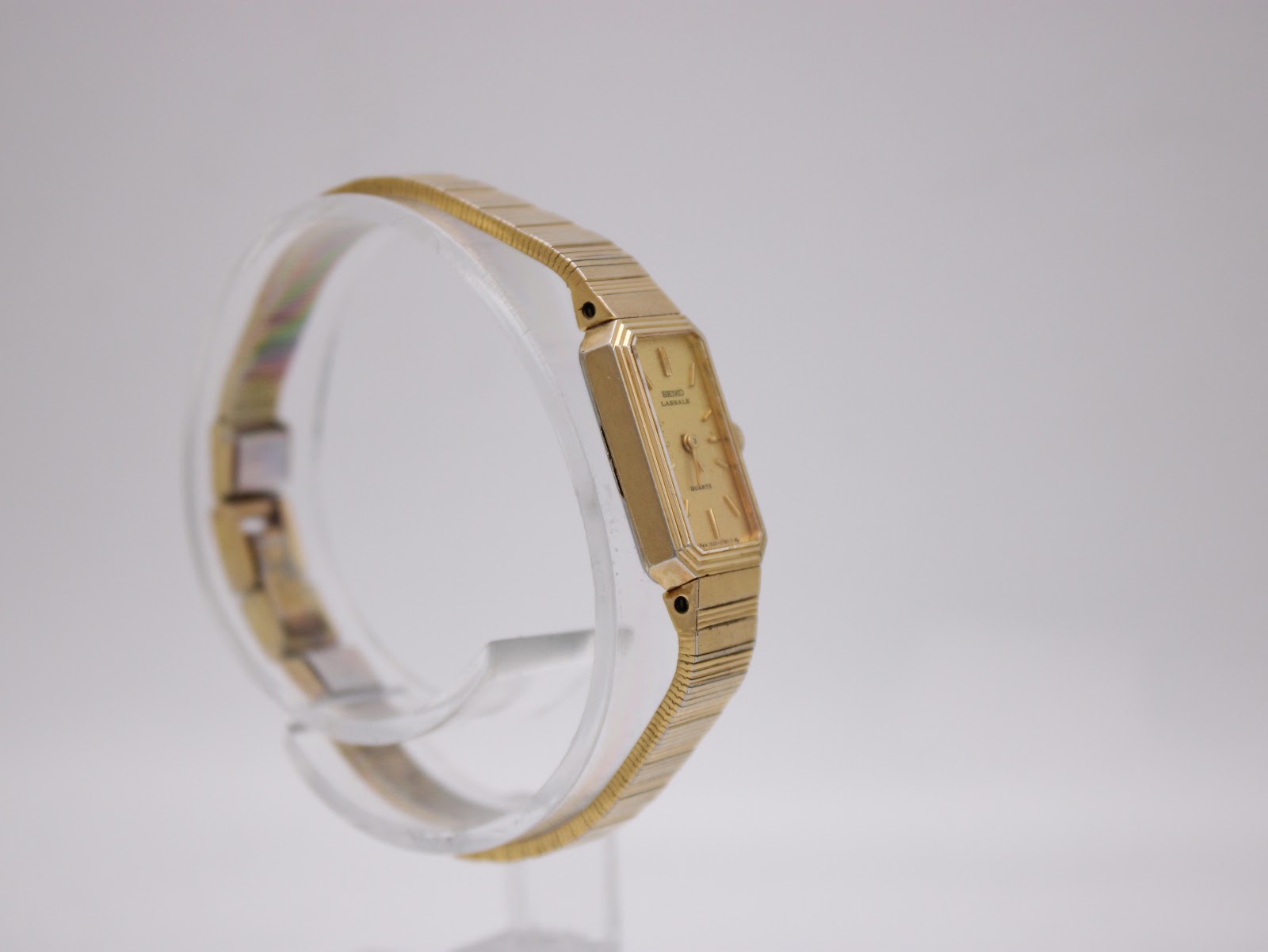 Another side view of the Seiko Lassale watch, highlighting the integrated design of the gold-tone rectangular case and expandable bracelet.