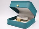 The Seiko Lassale watch displayed open inside a teal-coloured watch presentation box with a small gold crown emblem on top.