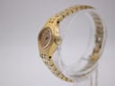 Side profile of the gold-plated Seiko watch, showing the textured case and crown details