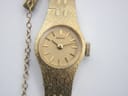 Detail of the gold-coloured textured steel bracelet and safety chain of the vintage Seiko ladies' watch
