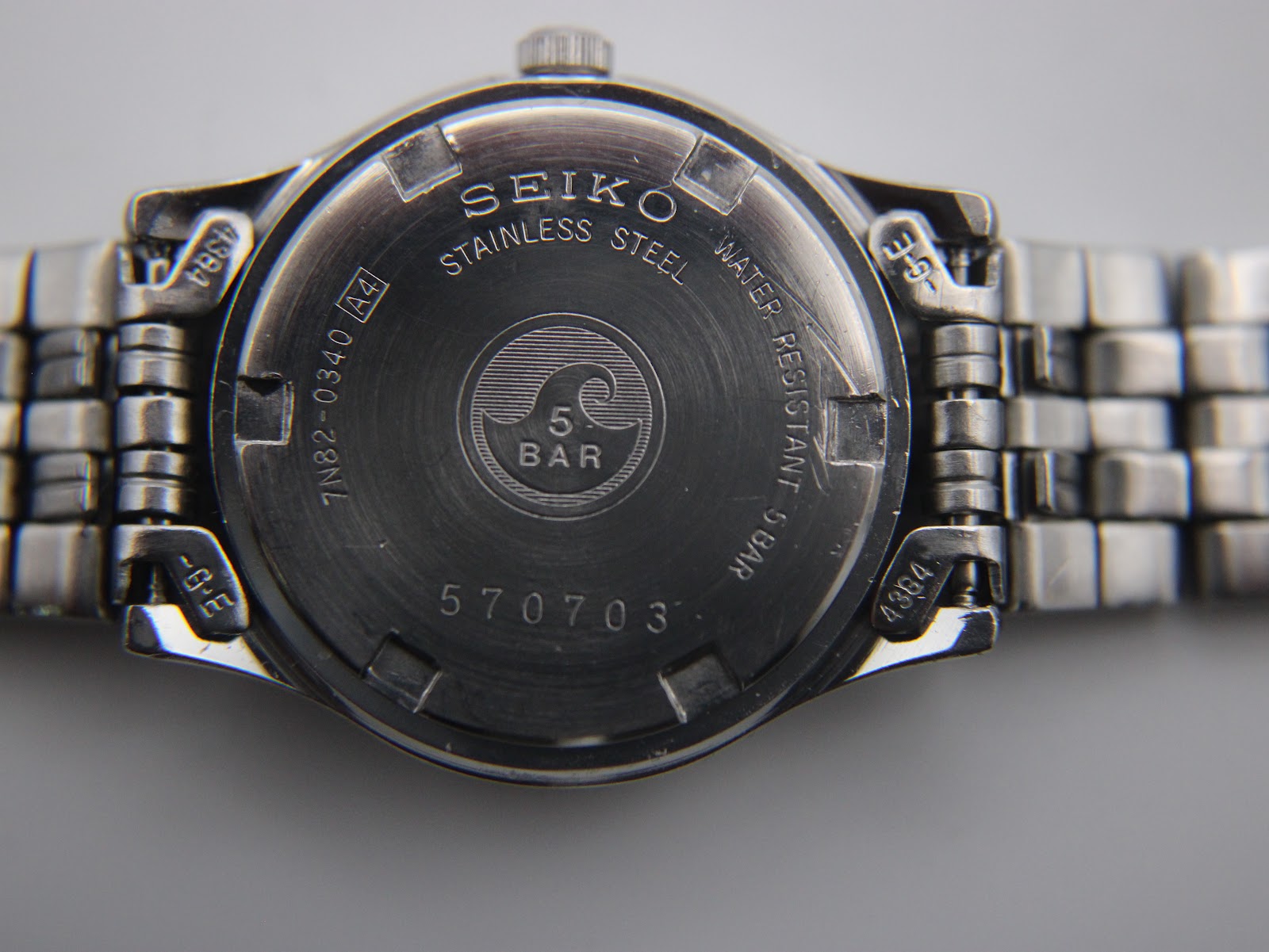Detailed view of the navy blue dial with applied baton indices and date window at 3 o'clock.