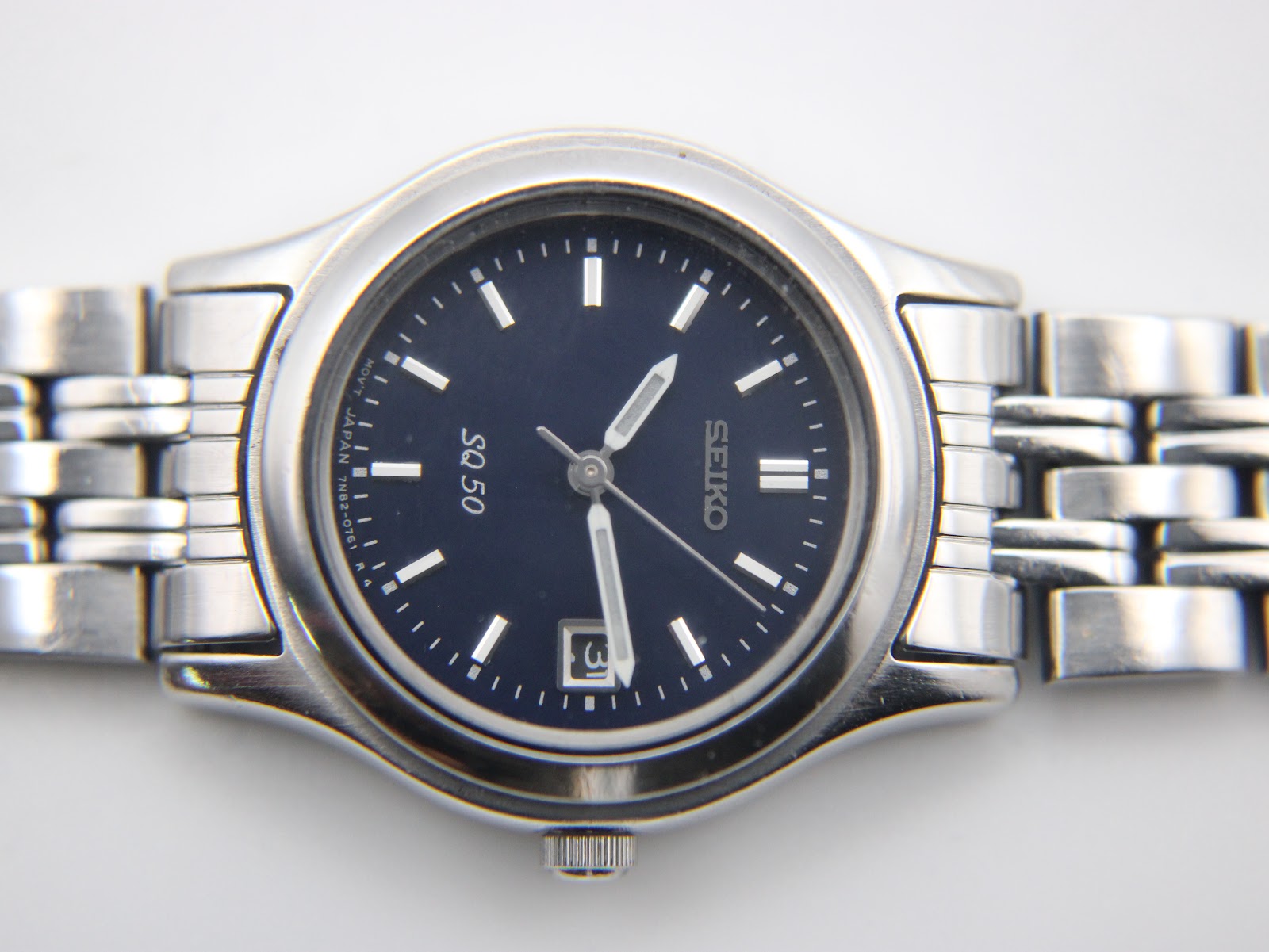 Rear view of the Seiko watch caseback, showing model number, serial, and water resistance marking.
