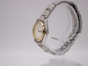 Side profile of vintage Seiko quartz watch showing two-tone case and crown.