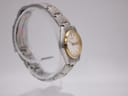 Detailed view of white dial on Seiko 7N83-0011 with gold-tone indices and hands.