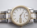 Close-up of Seiko two-tone stainless steel bracelet with gold accents and signed clasp.