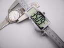 Digital caliper measuring the case diameter of the Seiko watch, displaying a precise measurement of 35.09mm.