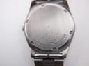 Detailed view of the dark blue dial with day-date window and "SQ" logo.