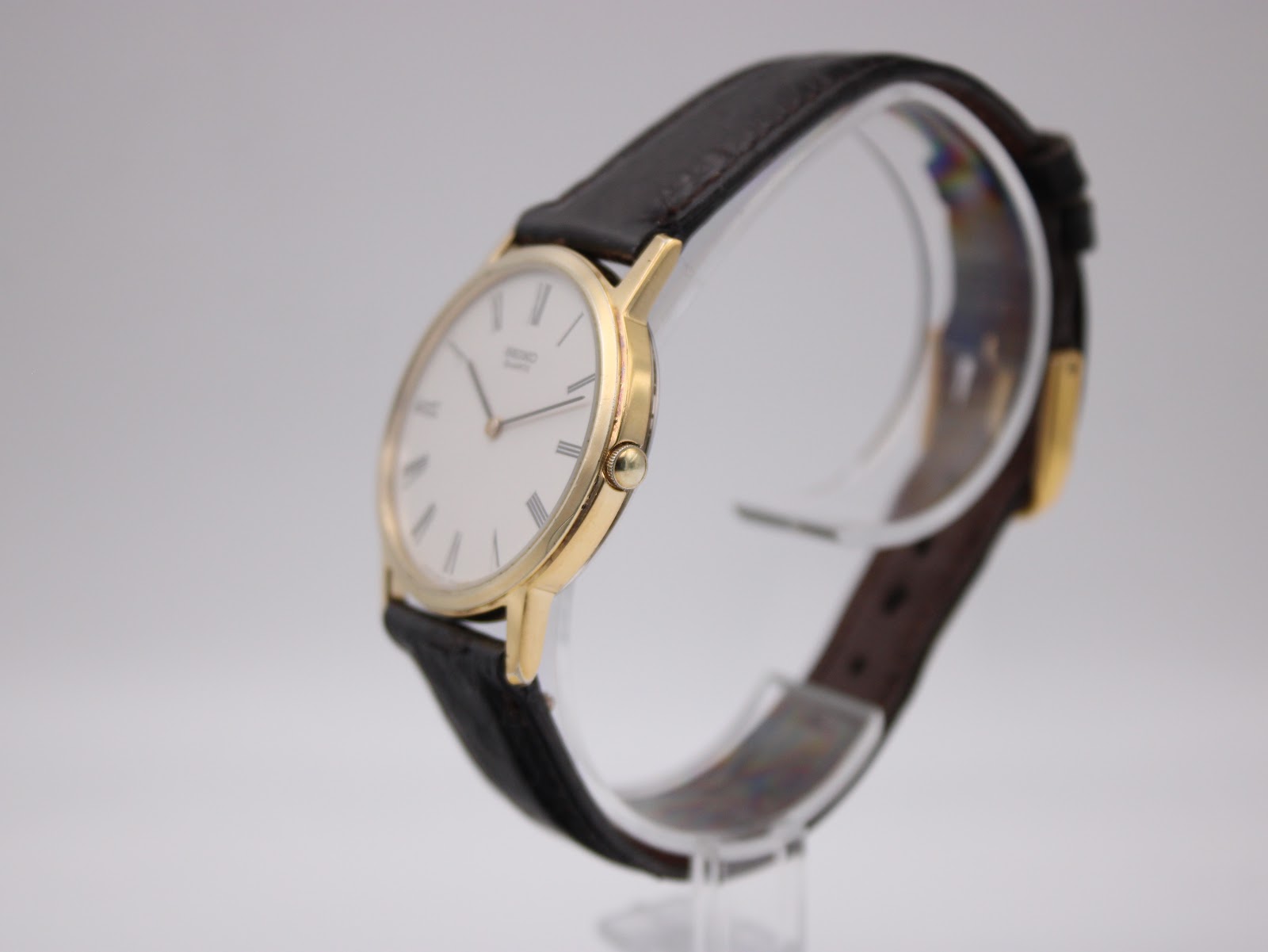 Side profile of the gold-plated Seiko dress watch, highlighting the slim case design.