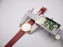 Digital caliper measuring the case diameter of the Seiko watch, displaying a precise measurement of 30.46mm.