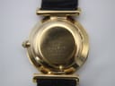 Close-up of the polished gold-plated case back, revealing engraved serial number 790780 and model 43-0170 with light surface scratches.