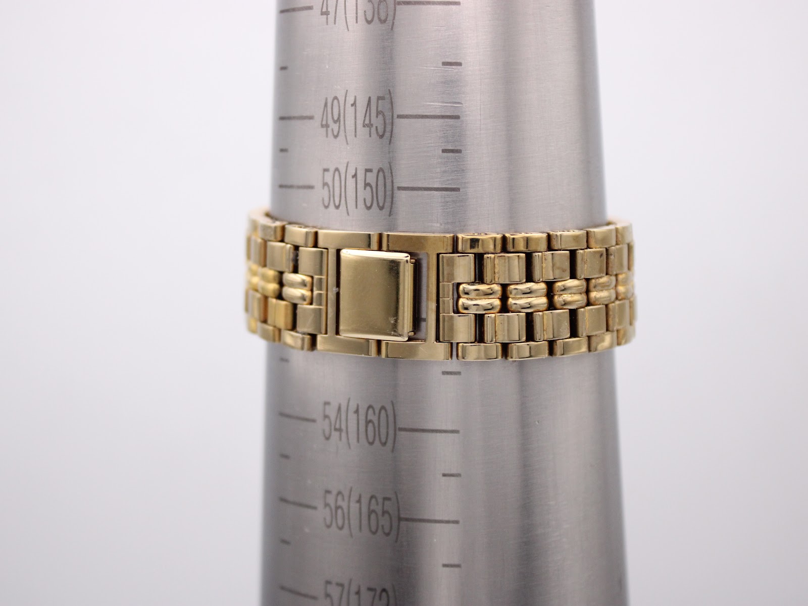 The gold-tone steel bracelet of the Seiko watch displayed on a wrist sizing gauge, indicating a circumference of approximately 153mm (15.3cm).