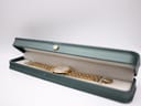 The Seiko V722-7051 watch resting inside a generic dark green presentation watch box.