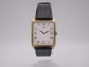 Front view of Seiko 6530-5200 vintage quartz watch with gold rectangular case and white Roman numeral dial.