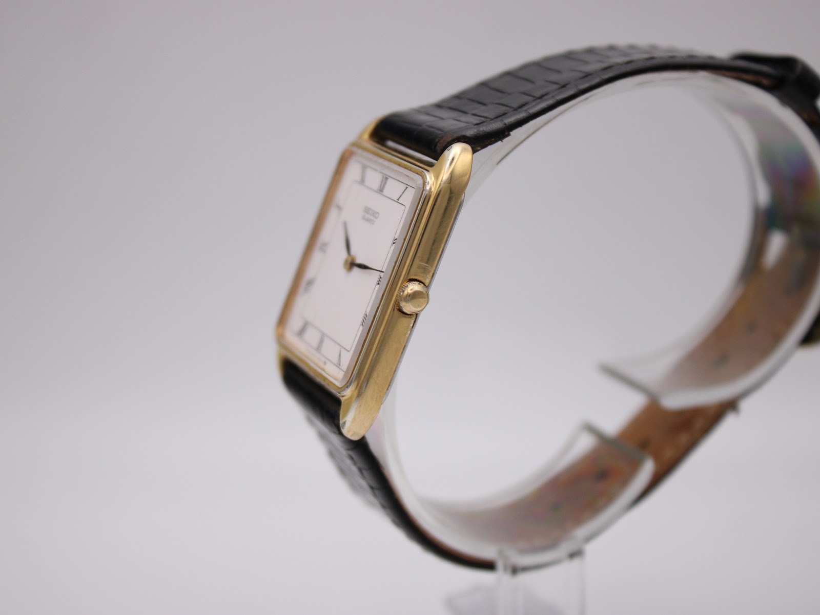 Side profile of the gold-plated Seiko watch, showing the thin case and crown.