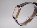 Side profile of the gold-plated Seiko watch, showing the thin case and crown.