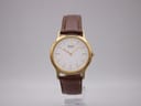 Front face of the Seiko V700-8A10 gold tone watch with white dial on a clear stand.