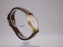 Close-up of the watch case back showing 'SEIKO BASE METAL ST. STEEL BACK V700-8A10' and serial number.