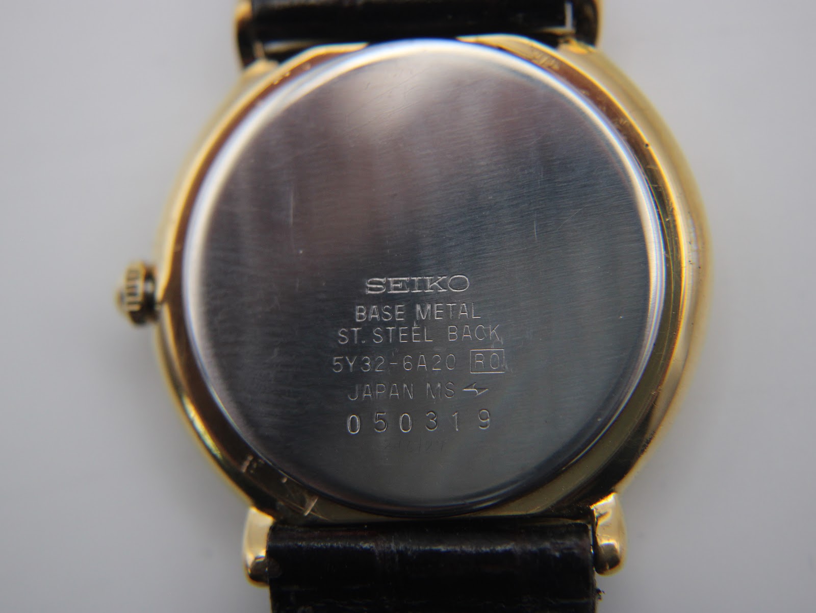 Close-up of the stainless steel case back, engraved with 'SEIKO BASE METAL ST. STEEL BACK 5Y32-6A20 JAPAN MS 050319'.