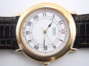 Detailed close-up of the white dial with black Roman numerals, red 'XII', inner 24-hour track, and date window.