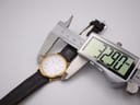 Digital caliper measuring the case diameter of the watch, displaying a precise measurement of 32.80mm.