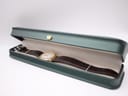 The Seiko watch lying in a generic green watch presentation box, showcasing its full length.