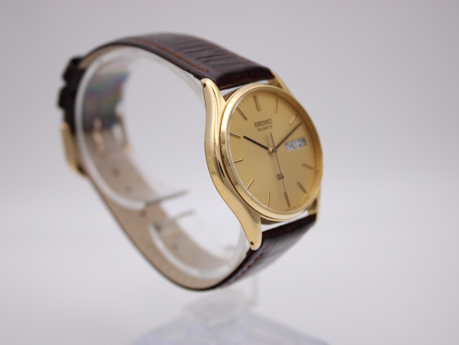 Another angled side view of the Seiko watch, highlighting the watch's slim profile and case curvature.