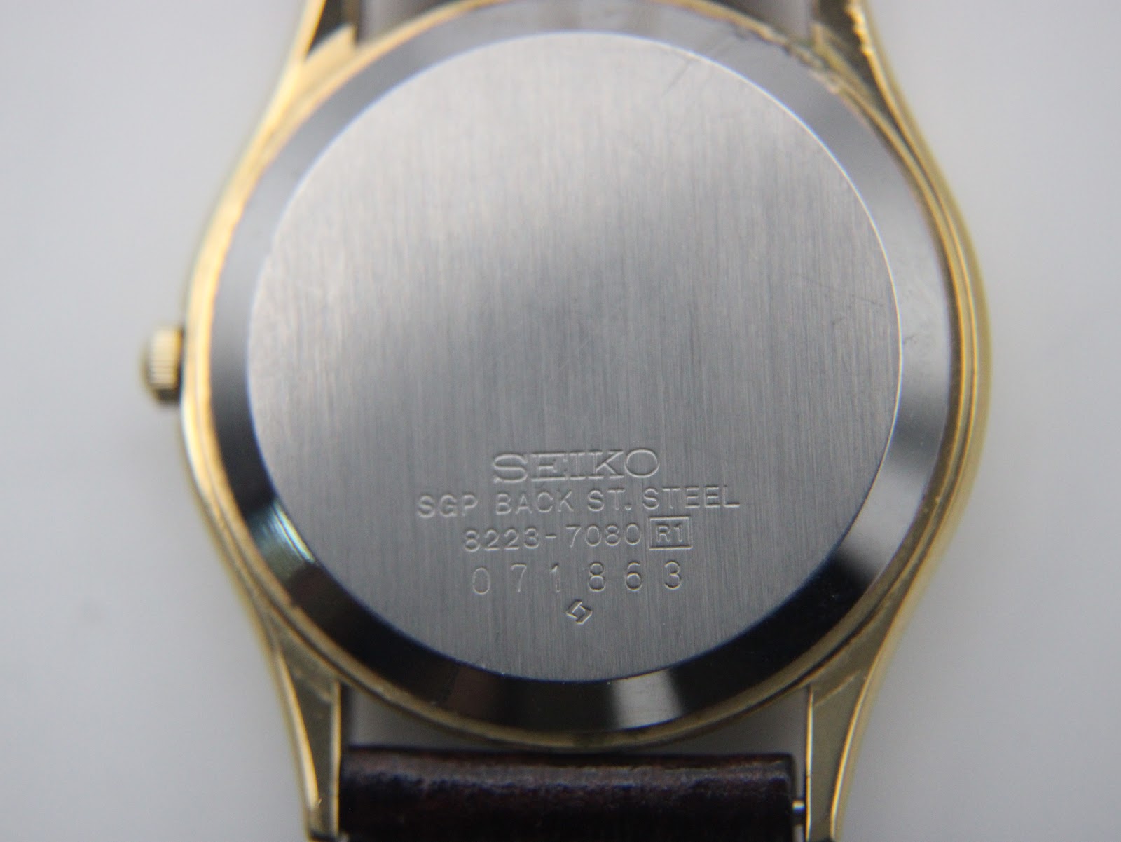 Close-up of the watch case back, showing 'SEIKO SGP BACK ST. STEEL 8223-7080 R1 071863' engravings.