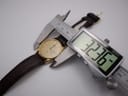 Digital caliper measuring the case diameter of the Seiko watch, showing a reading of 32.36mm.