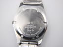 Close-up of the stainless steel case back of the Seiko watch, displaying engravings including 'SEIKO', 'WATER RESISTANT', serial number '131789', 'JAPAN-KY', and model number '7123-8430-P'.