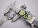 Digital caliper measuring the watch case diameter, clearly displaying a measurement of 34.53mm.