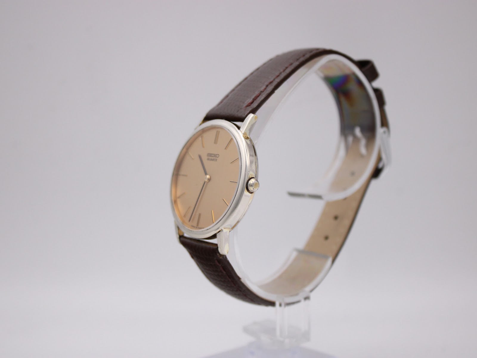 Angled side view of the Seiko watch, showcasing its slim profile and the crown on the right.