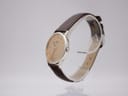 Angled side view of the Seiko watch, showcasing its slim profile and the crown on the right.
