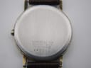 Close-up of the watch's stainless steel case back, engraved with "BASE METAL TOP", "ST. STEEL BACK", "7800-7009", and serial "9N3002".