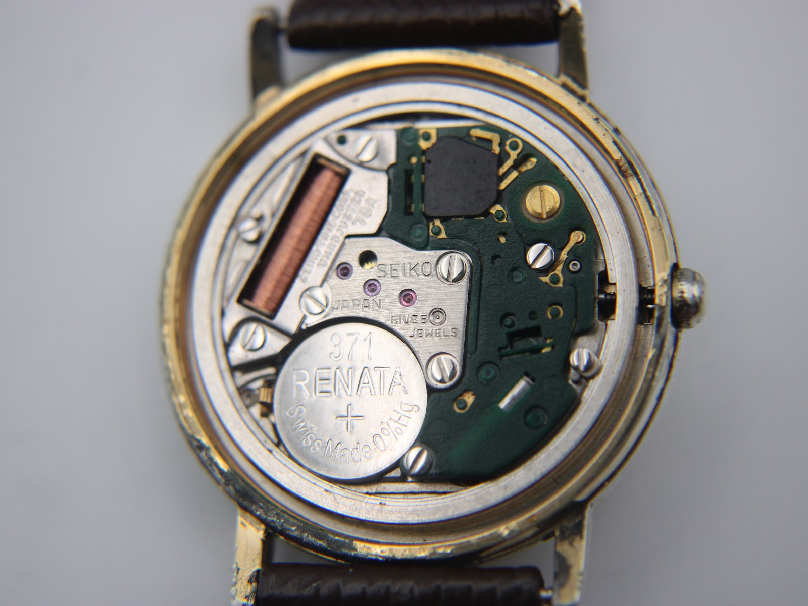 Macro shot of the Seiko 7800 quartz movement, showing the "SEIKO JAPAN 5 JEWELS" engraving and a fitted Renata 371 battery.