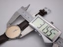 A digital caliper measuring the case diameter of the Seiko watch, displaying a precise measurement of 31.55mm.