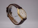 Another angled view of the Seiko watch, highlighting the case profile and brown leather strap, visible buckle.