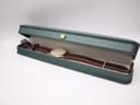 The Seiko watch presented in a generic dark green watch box with a gold crown emblem.