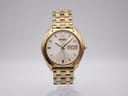 Front view of gold-tone Seiko V743-8069 quartz watch with silver dial and integrated steel bracelet.