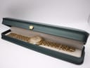 The pre-owned Seiko watch resting inside a generic green presentation box.