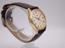 Another angled side view of the vintage Seiko watch, highlighting the curved lugs and the watch's profile on a stand.
