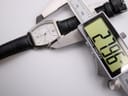 Digital caliper measuring the case width of the Orient UNBH-CO watch, displaying 27.06 mm.