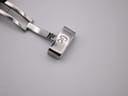 Close-up of the polished silver-tone deployant clasp with "Gc" logo engraved.