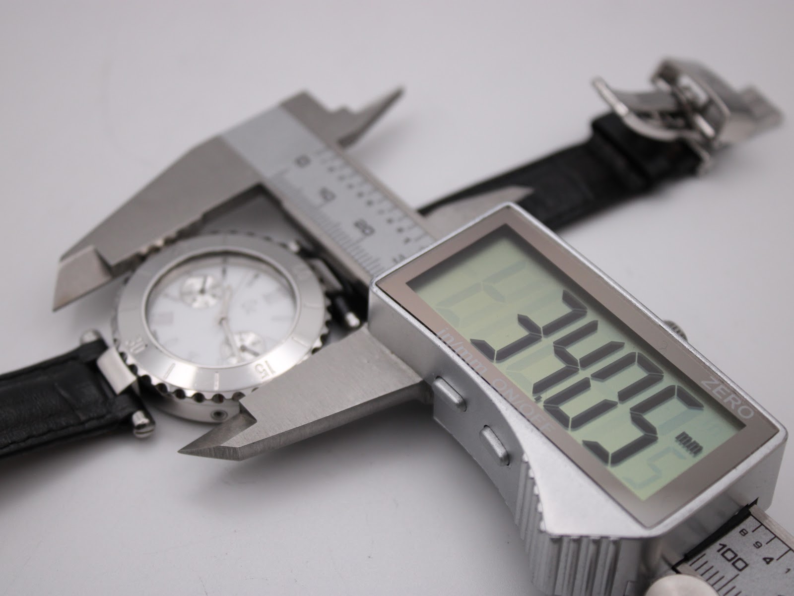 Digital caliper measuring the case diameter of the Gc watch at 34.05mm, with the strap extended.
