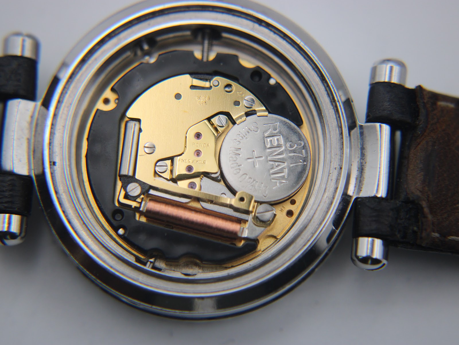 Open case back showing the Swiss Ronda quartz movement and Renata 371 battery.