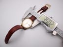 Digital caliper measuring the case diameter of the Seiko watch, showing 35.02mm.