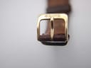 Close-up of the gold-tone buckle, clearly showing the 'SEIKO' signature.