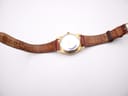 Full top view of the Seiko watch with the brown leather strap laid flat on a white surface.
