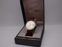 Front view of the Seiko watch displayed in its original black and gold Seiko box.
